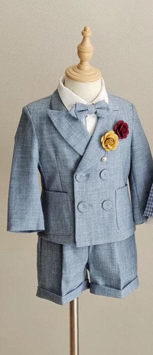 Elegant 3-piece blue linen boy wedding outfit featuring a double-breasted blazer, bow tie, and tailored shorts, perfect for formal events and special occasions.
